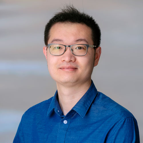 Xuan Wang wears a collared, blue shirt and glasses in his faculty profile for Mason's Department of Electrical and Computer Engineering