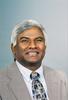 Mason Professor Rao Mulpuri wears a gray suit and patterned tie in his faculty profile